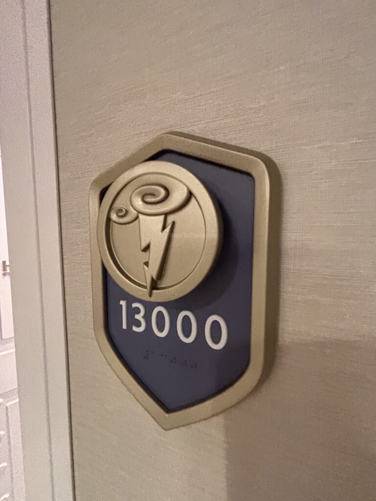 Room number sign displaying '13000' with a decorative emblem.
