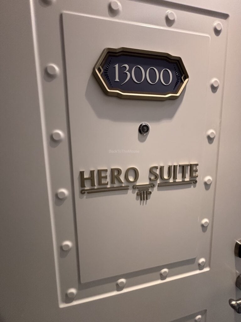 Close-up of the door to Stateroom 13000, labeled 'HERO SUITE' on a cruise ship.