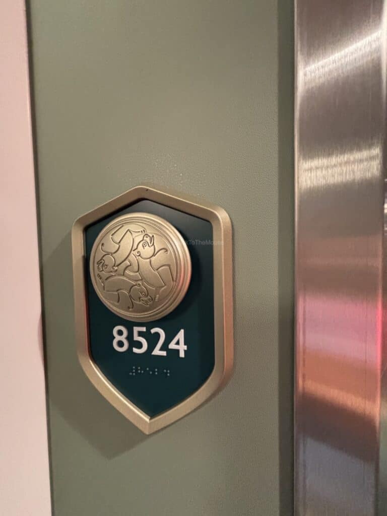 Close-up of the door sign for Stateroom 8524 on the Disney Destiny, featuring the room number and a decorative emblem.